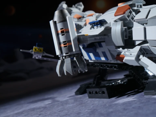 Side view of the deep-space cargo freighter with escort craft and stand